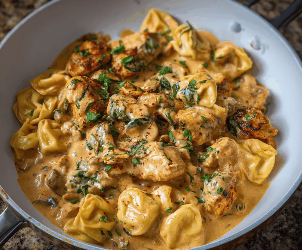 Creamy Marry Me Chicken Tortellini served with fresh herbs and parmesan cheese, featuring tender tortellini in a rich, savory sauce perfect for a romantic dinner.