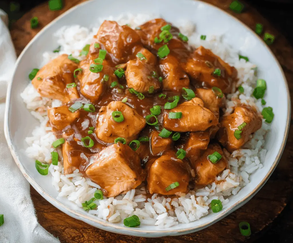 Delicious Crock Pot Bourbon Chicken served with vegetables and rice, showcasing a flavorful, easy-to-make slow cooker recipe
