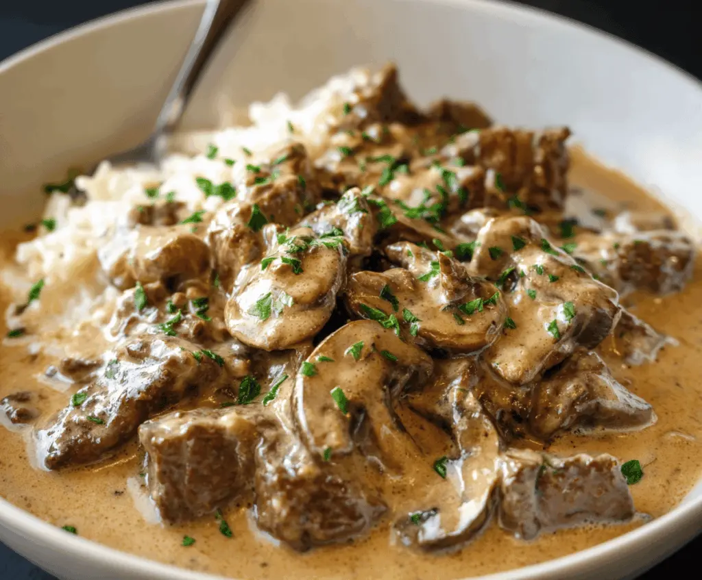Creamy Gordon Ramsay Beef Stroganoff served with tender beef strips, mushrooms, and herbs on a white plate, perfect for a hearty and flavorful meal.