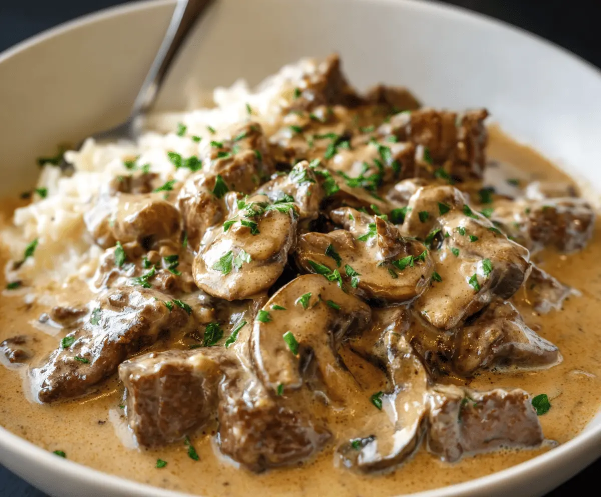 Creamy Gordon Ramsay Beef Stroganoff served with tender beef strips, mushrooms, and herbs on a white plate, perfect for a hearty and flavorful meal.