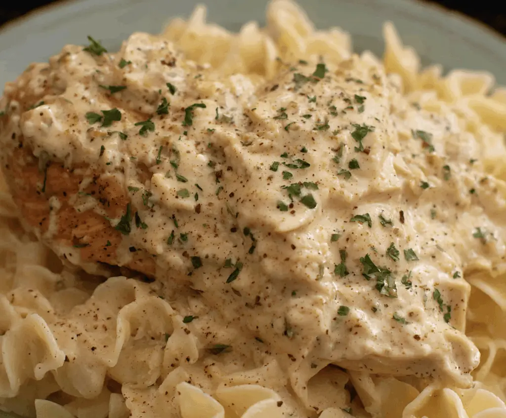 Creamy ranch chicken cooking in a crockpot, topped with fresh herbs, ready to serve for a flavorful and easy dinner recipe