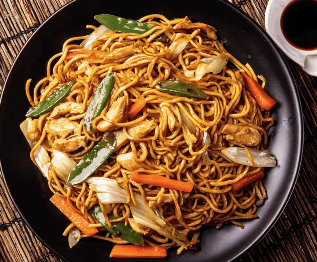 Delicious Chicken Chow Mein with stir-fried vegetables and noodles on a plate.