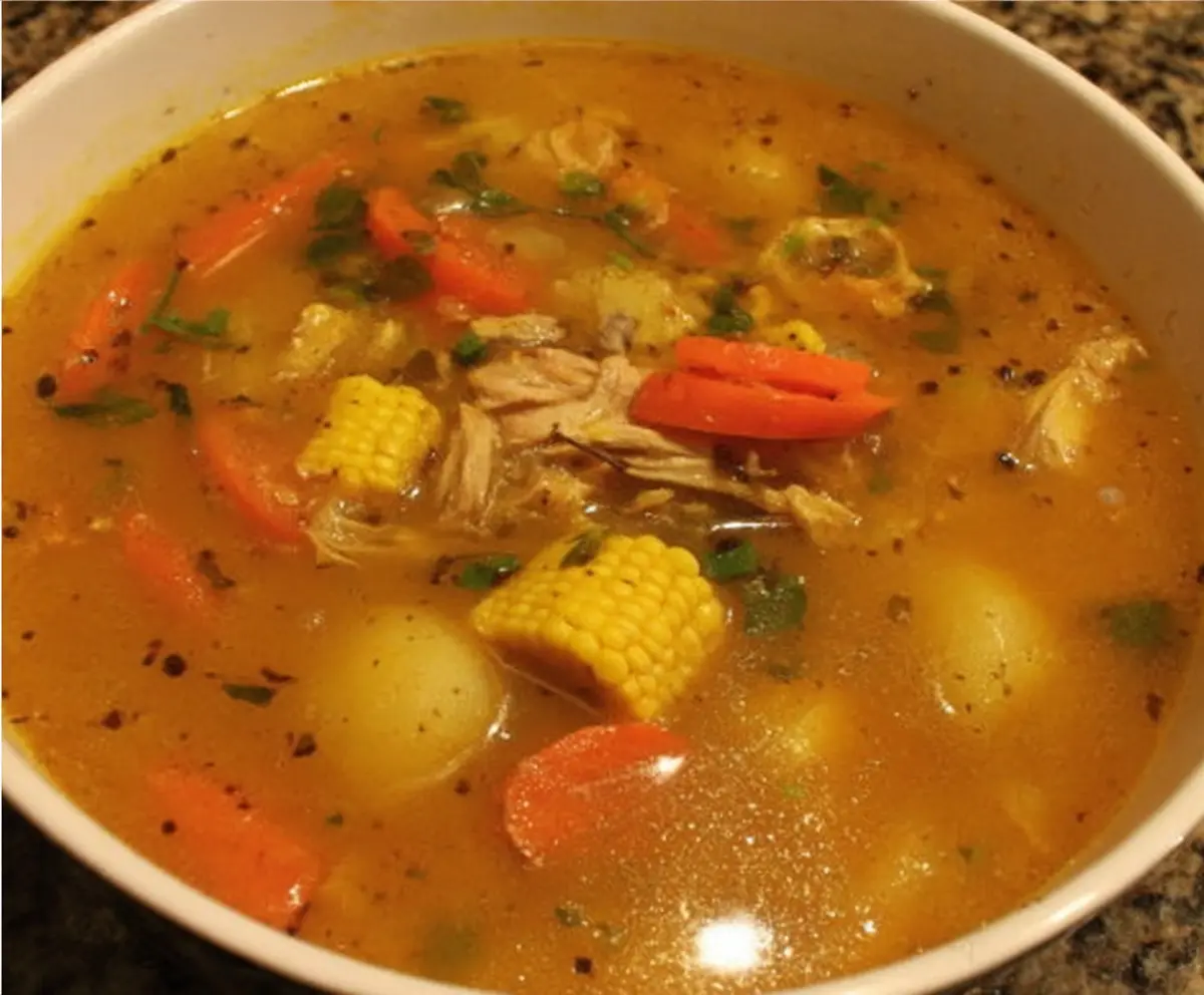 Hearty Jamaican Chicken Soup with vegetables and spices in a bowl.